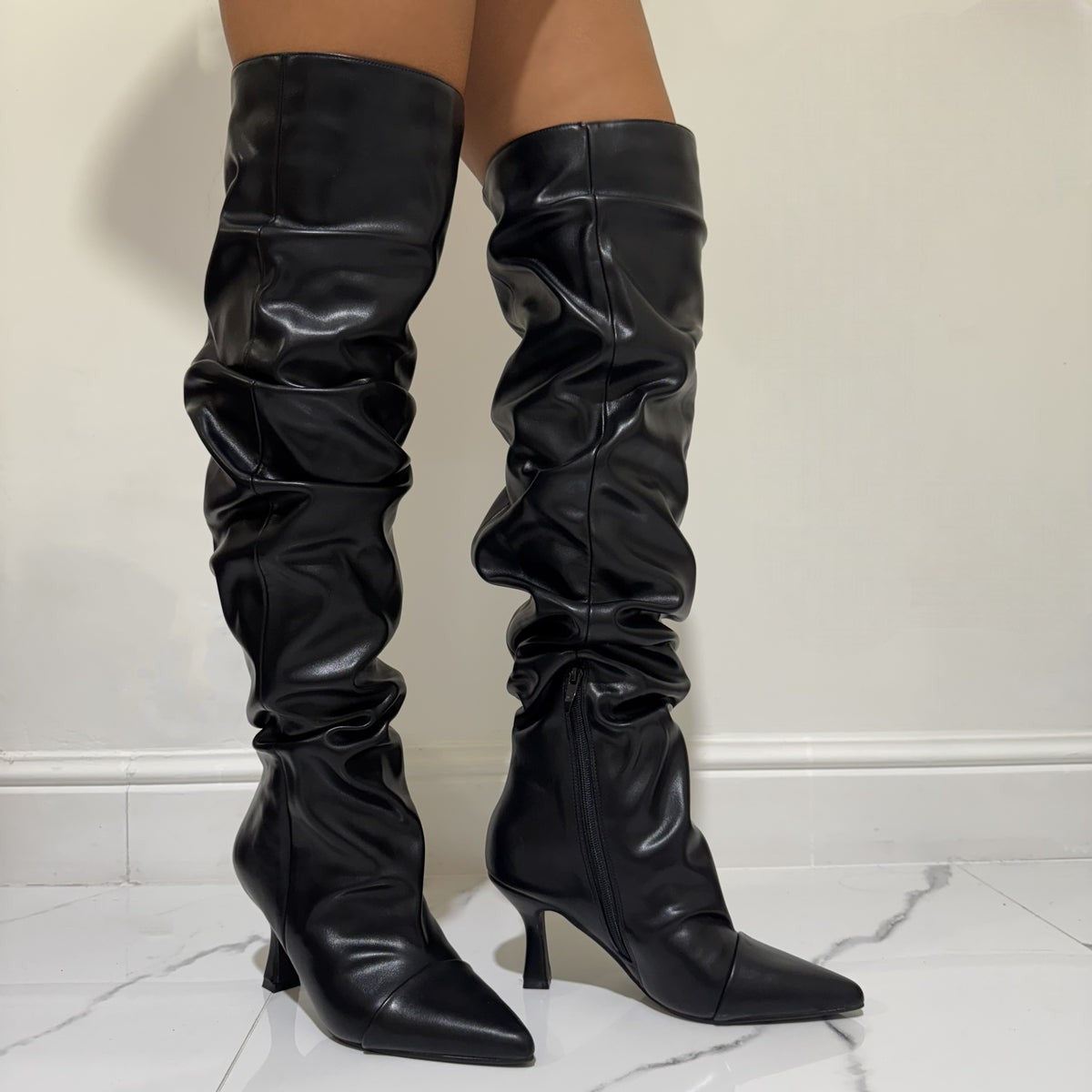 Black high boots with a thin heel