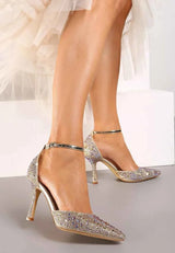 Gold heels on a thin heel