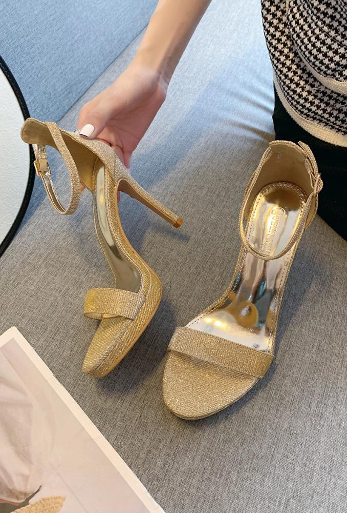 Gold sandals on a thin heel