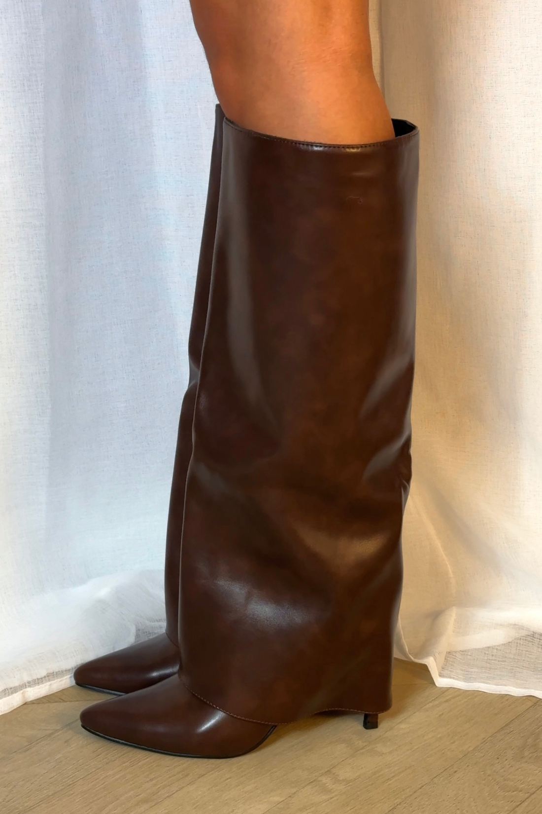Brown folded boots with a thin heel