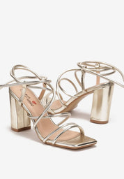 Gold sandals on a thin heel
