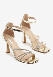 Gold sandals on a thin heel
