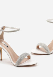White sandals with a thin heel