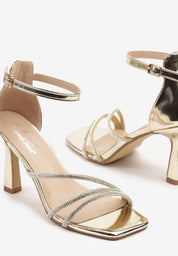 Gold sandals on a thin heel
