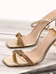 Gold sandals on a thin heel