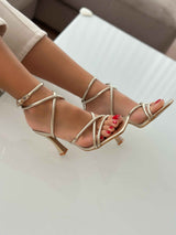 Gold sandals on a thin heel