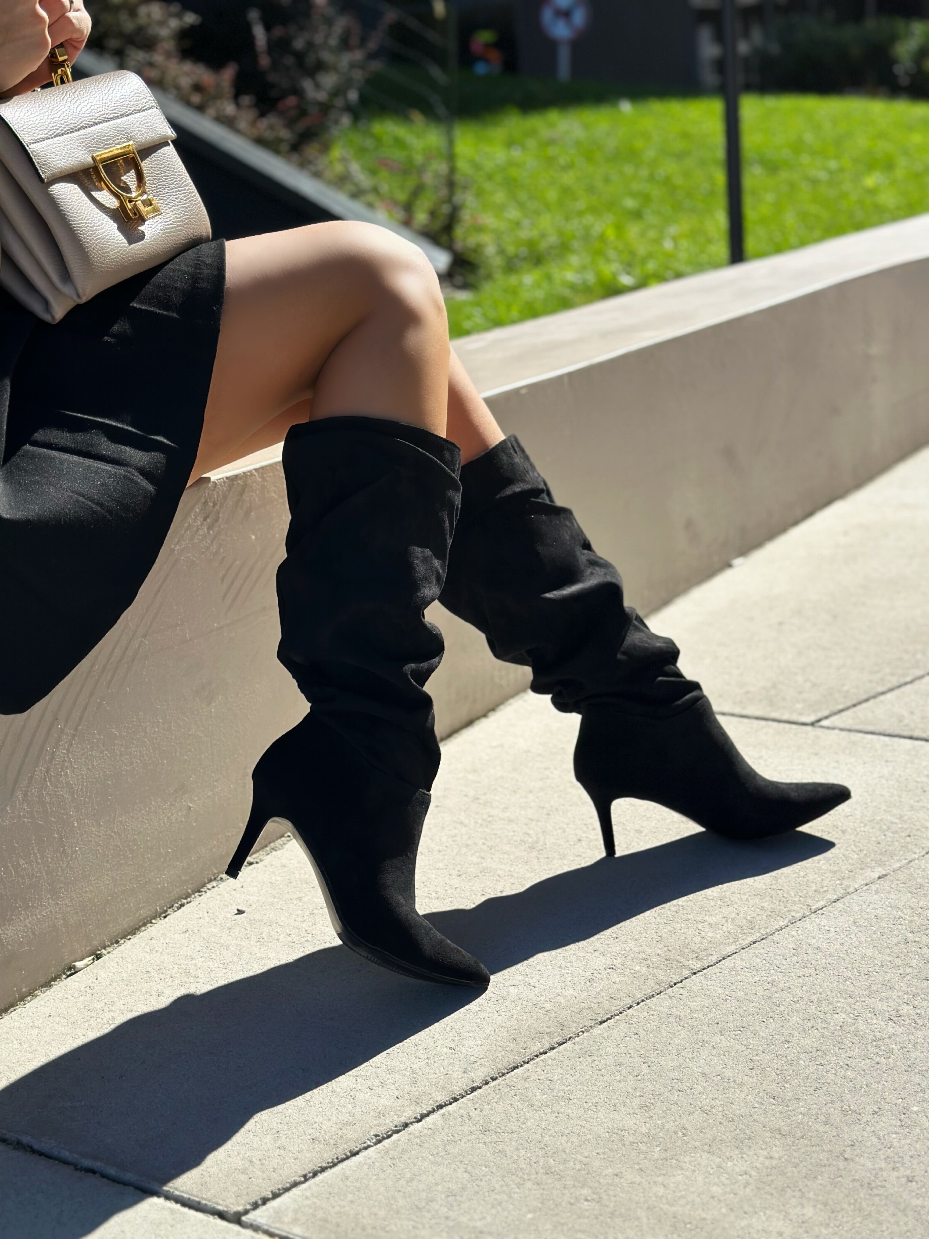 Black polished boots with a thin heel