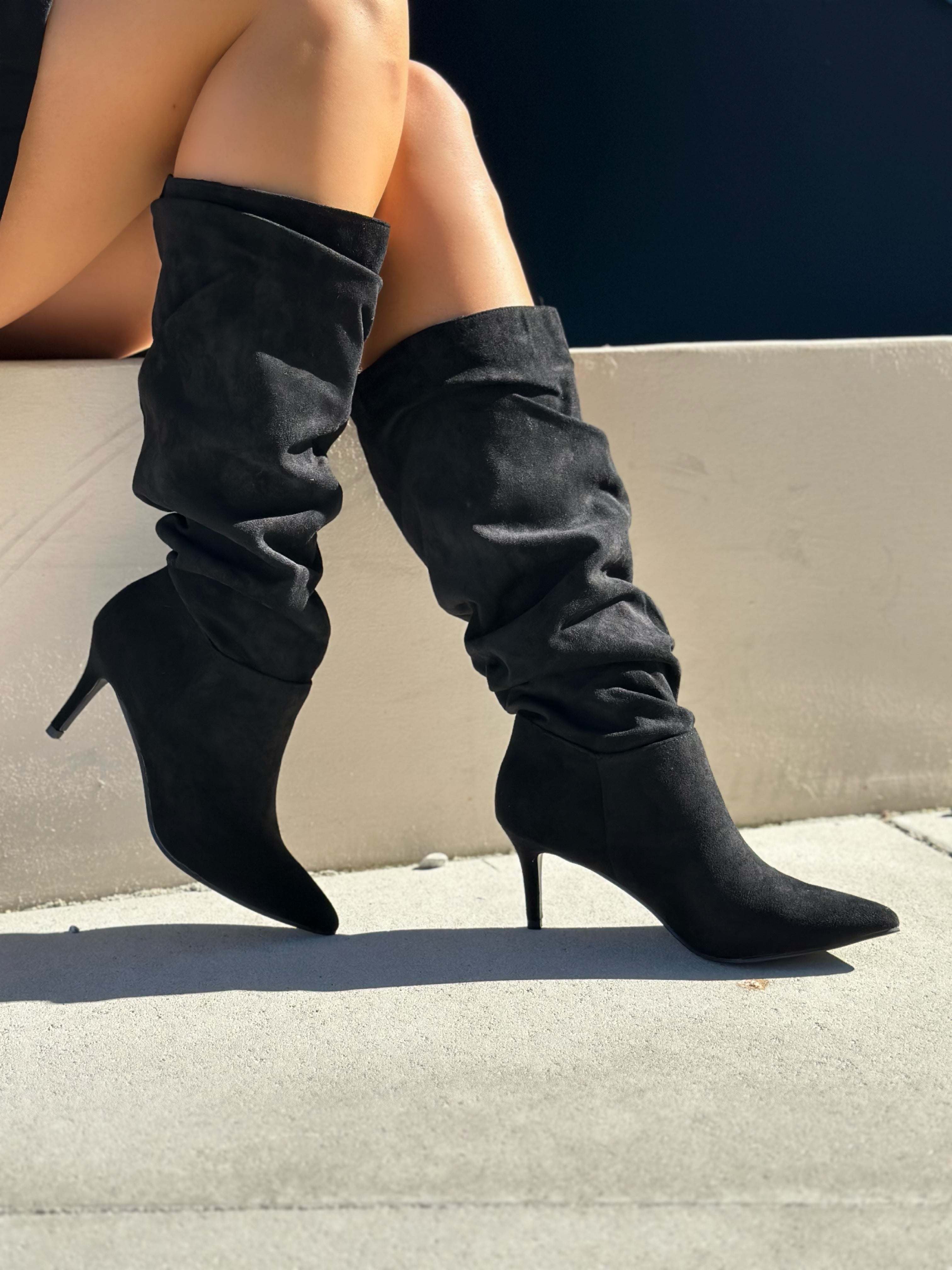Black polished boots with a thin heel