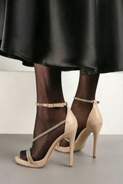 Nude sandals with thin heels.