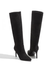 Black polished boots with a thin heel