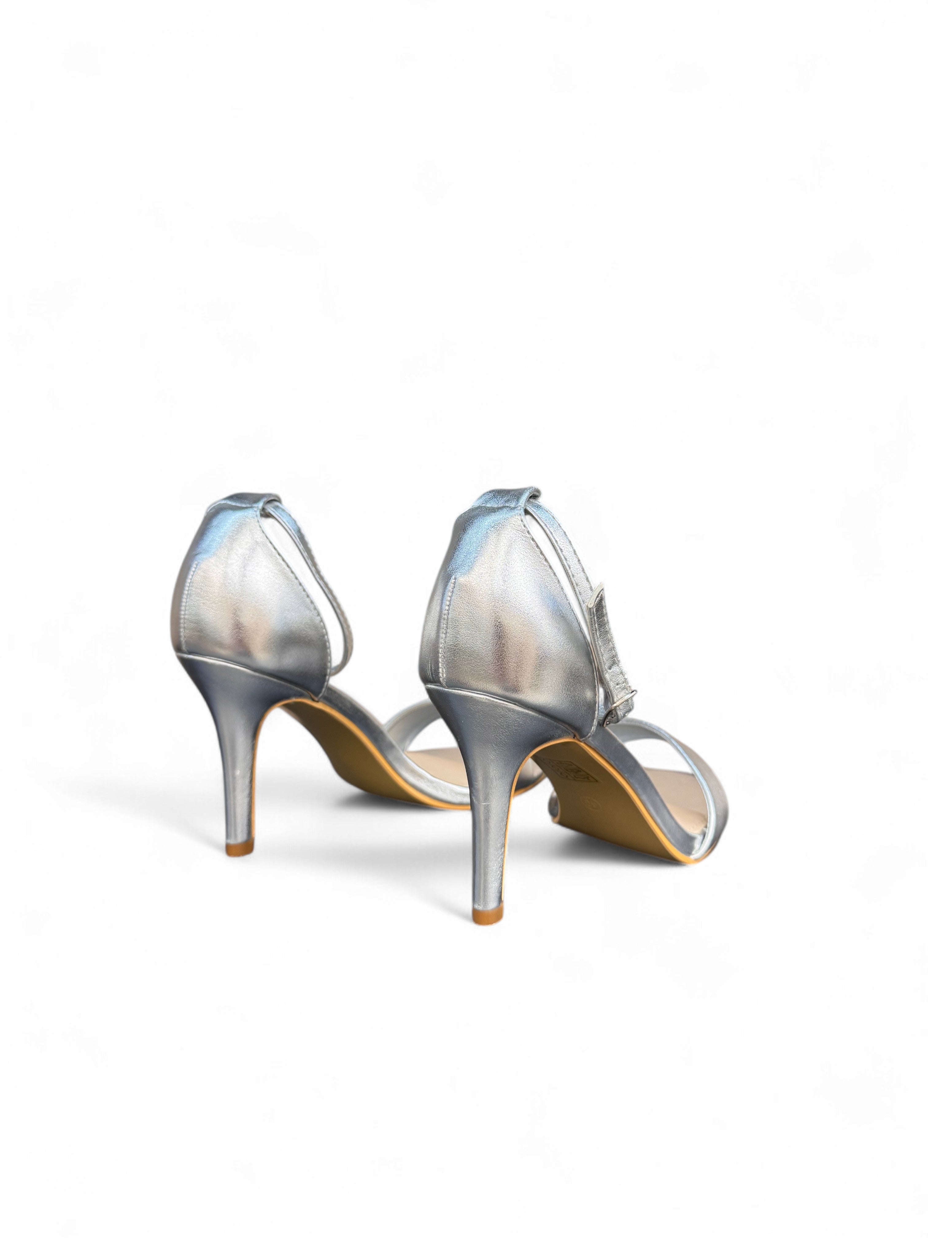 White sandals with a thin heel